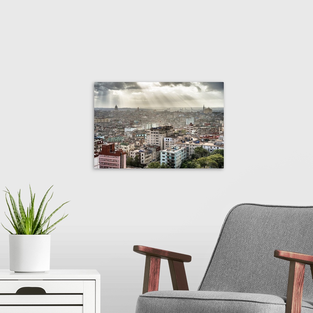 A modern room featuring Beautiful photograph of the sun beaming through the clouds over the city of Havana.