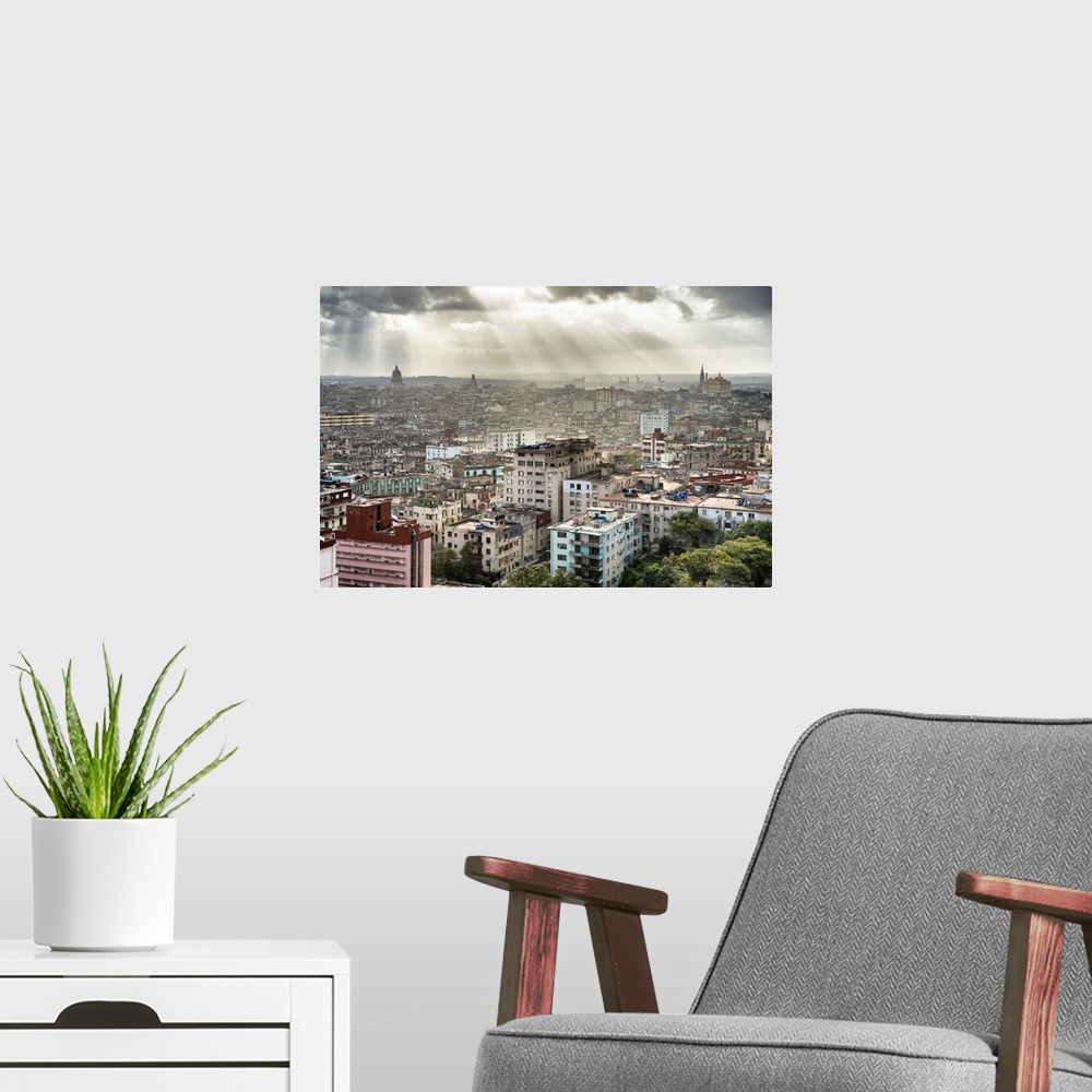 A modern room featuring Beautiful photograph of the sun beaming through the clouds over the city of Havana.