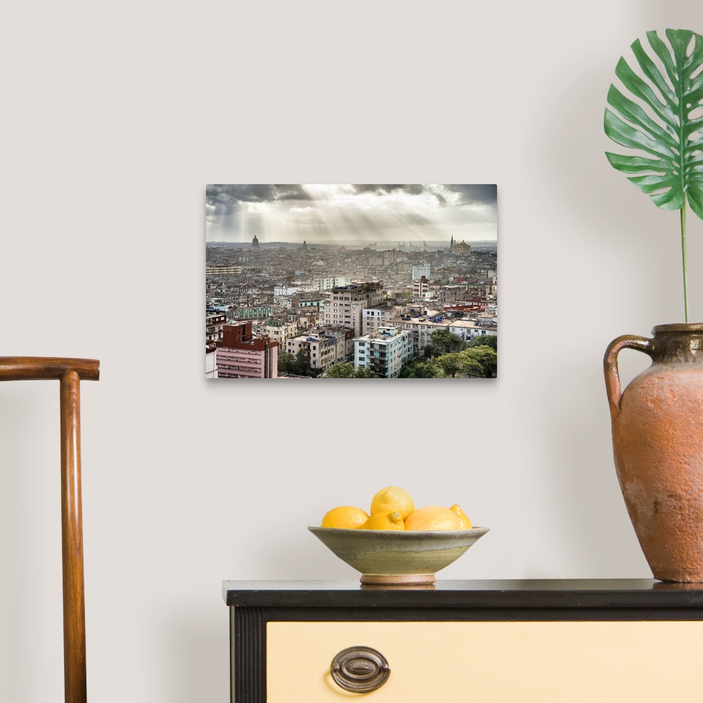 A traditional room featuring Beautiful photograph of the sun beaming through the clouds over the city of Havana.