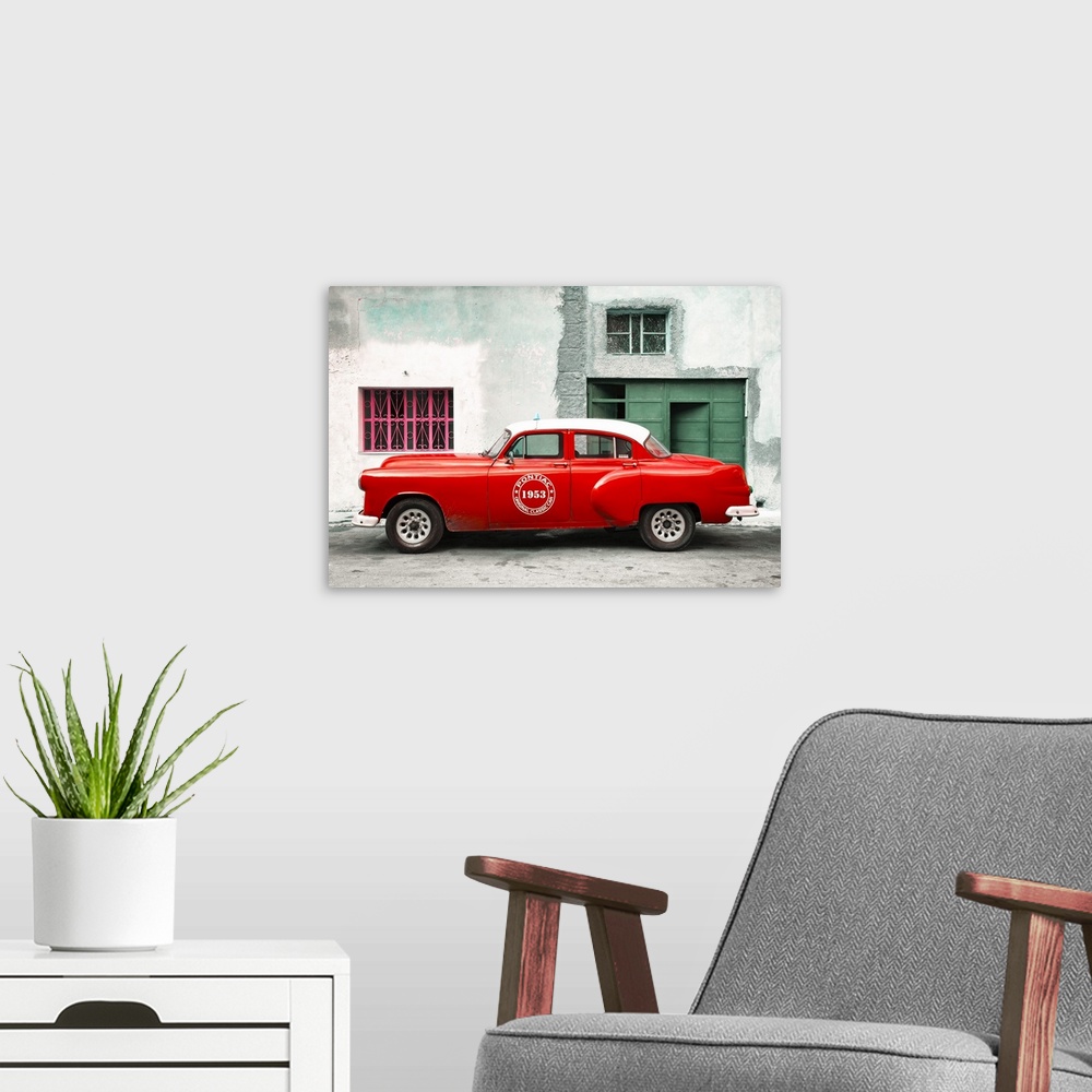 A modern room featuring Photograph of a vintage red Pontiac Original Classic Car from 1953 parked on the streets of Havana.