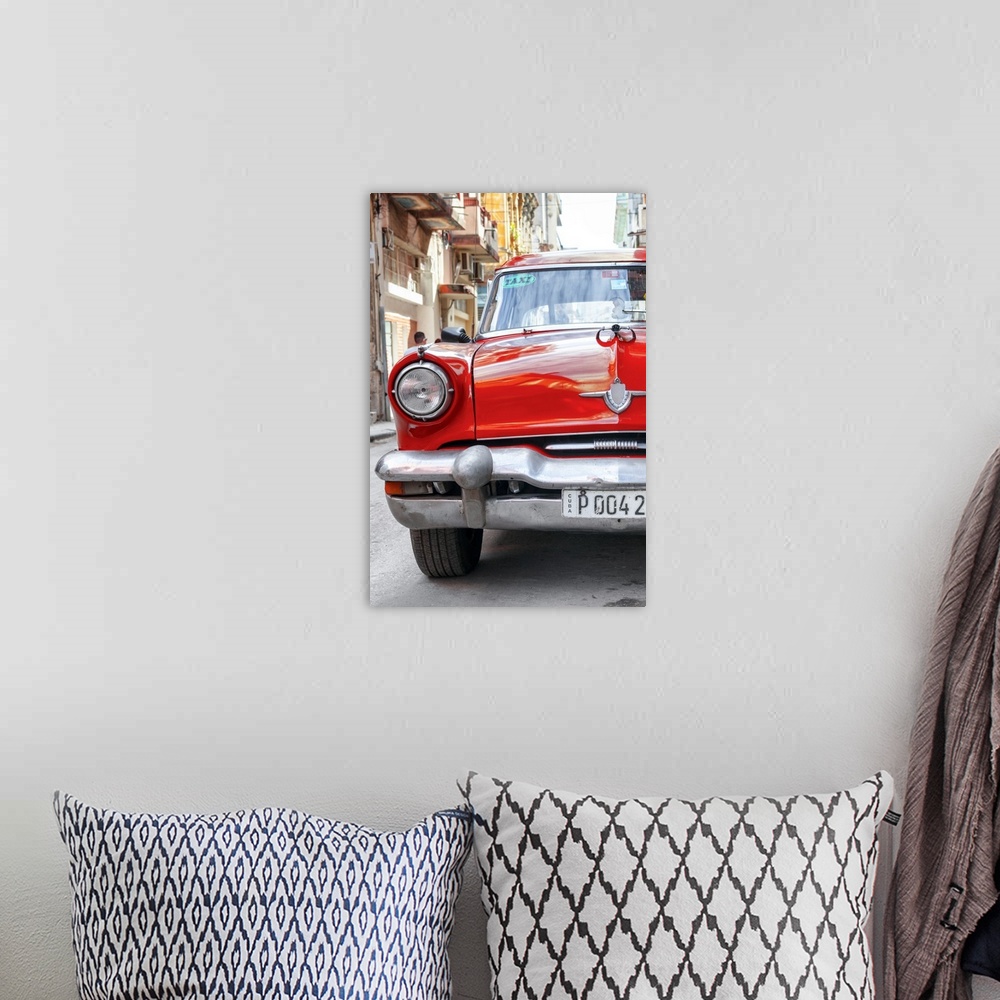 A bohemian room featuring Photograph of the front of a bright red taxi cab in Havana.