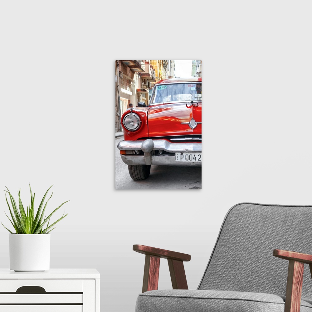 A modern room featuring Photograph of the front of a bright red taxi cab in Havana.