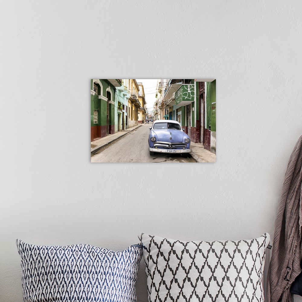 A bohemian room featuring Photograph of a blue vintage Ford car parked in a Havana street surrounded by buildings.