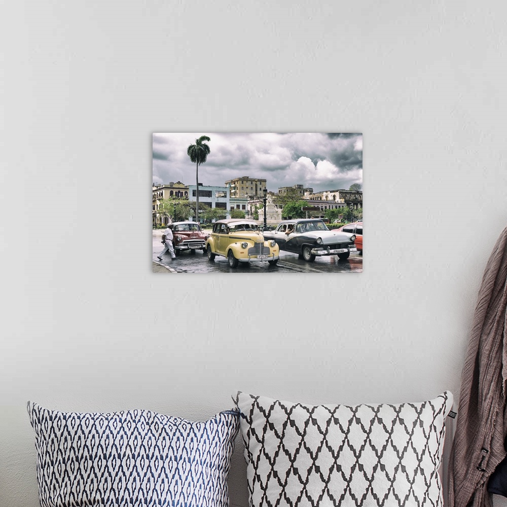 A bohemian room featuring Photograph of dramatic rain clouds above a Havana street scene with vintage cars and taxis.