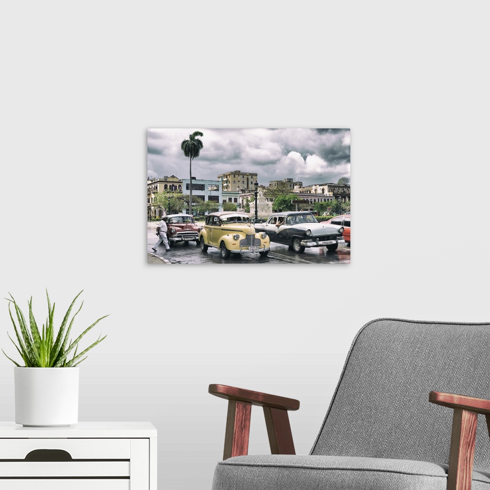 A modern room featuring Photograph of dramatic rain clouds above a Havana street scene with vintage cars and taxis.
