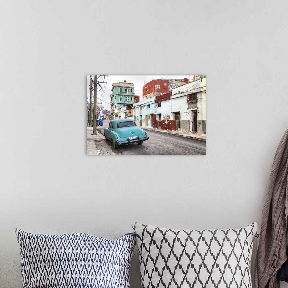 A bohemian room featuring Photograph of a vintage turquoise car parked in the street surrounded by worn buildings in Havana...