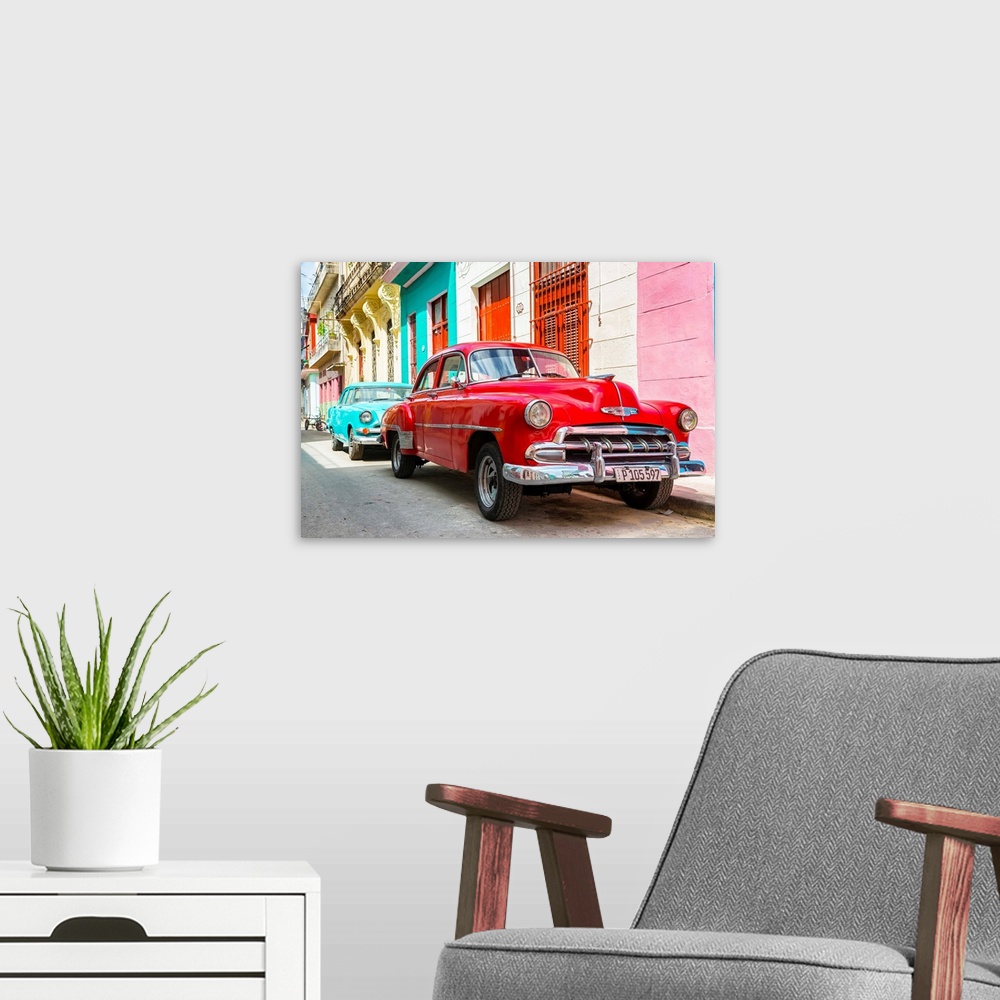 A modern room featuring Photograph of a turquoise and a red vintage Chevrolets parked along a colorful Havana street scene.