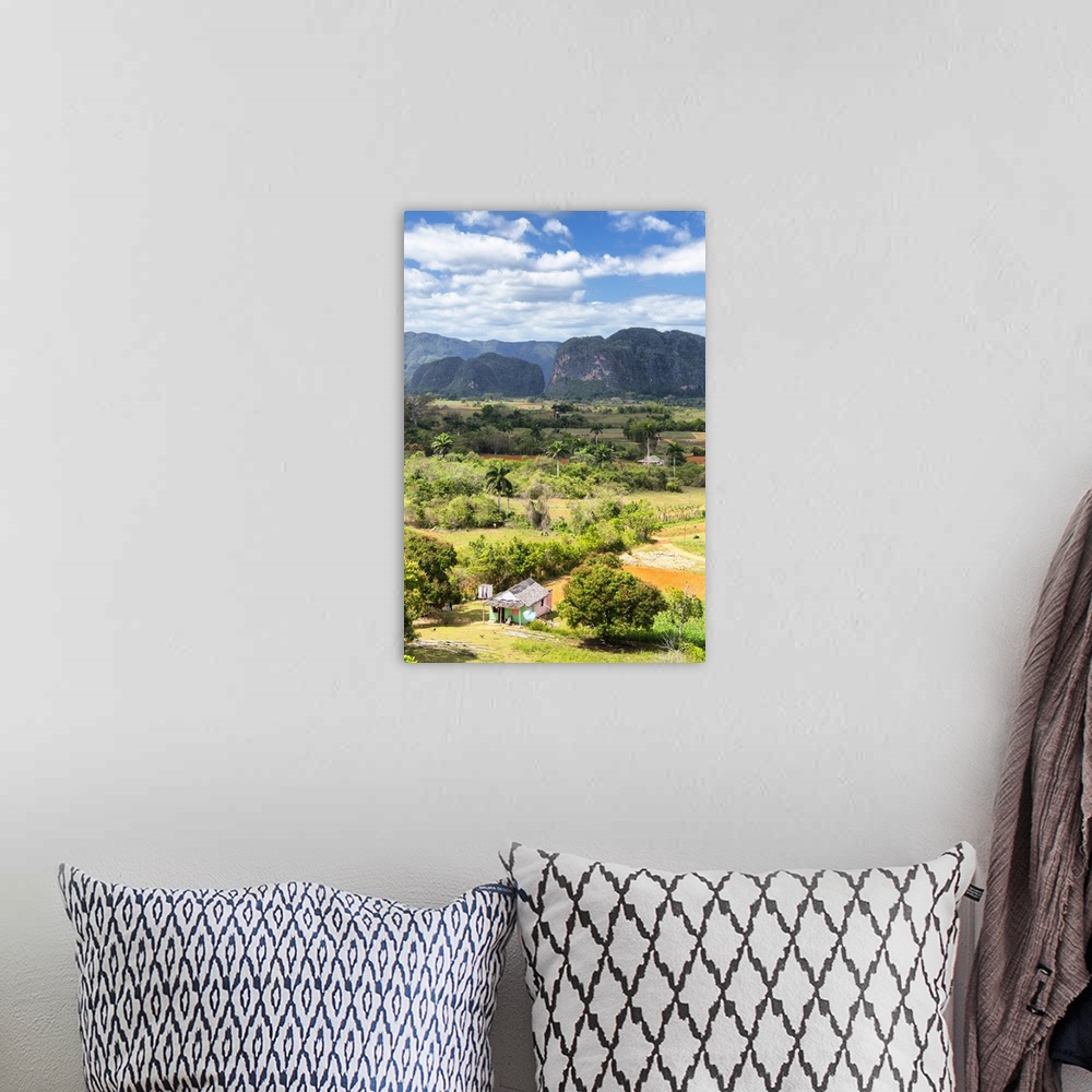 A bohemian room featuring Vertical landscape photograph of  Vinales Valley in Ciba with a green and pink hut in the foregro...