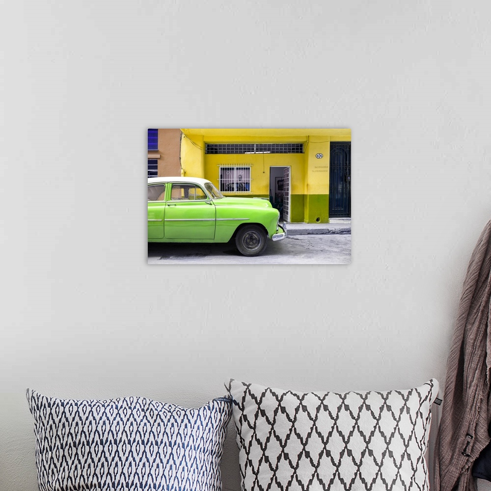 A bohemian room featuring Photograph of a bright green vintage car parked on the road in Havana with a bright yellow facade...