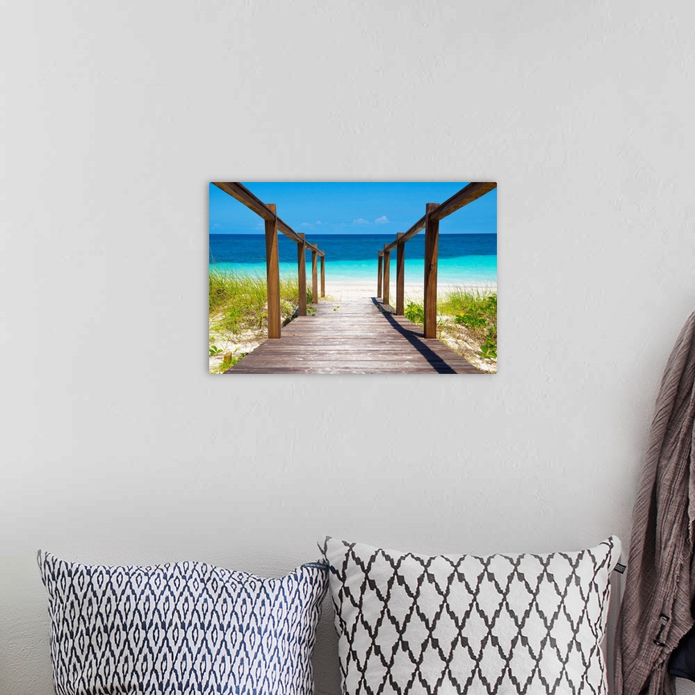 A bohemian room featuring Photograph of a wooden walkway leading straight to the white sands and crystal blue waters of a b...