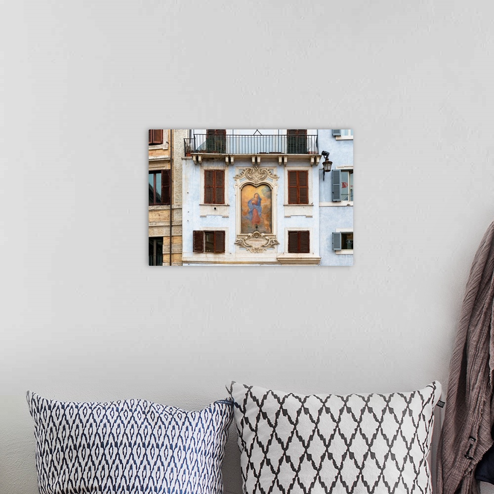 A bohemian room featuring This is a building facade with a painting of Affresco della Madonna on Piazza della Rotonda in Ro...