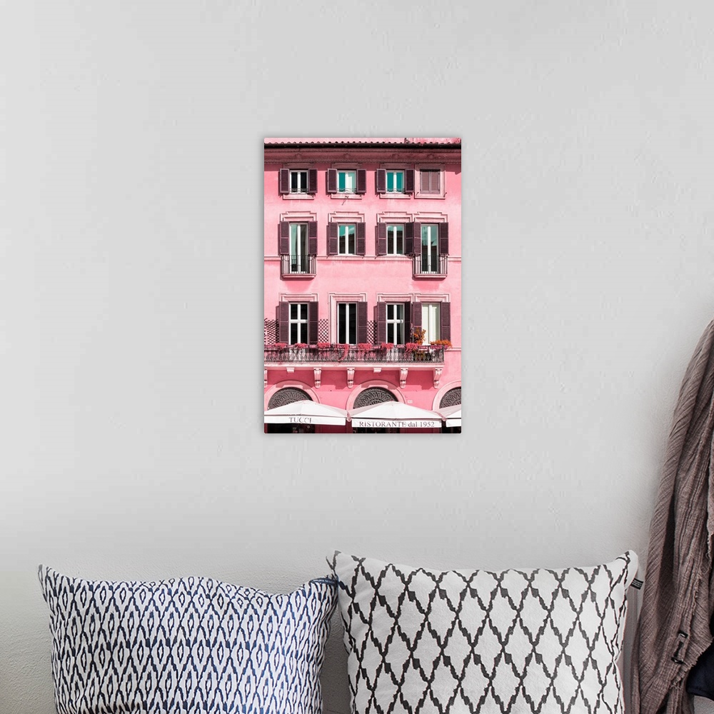 A bohemian room featuring It's a pink facade of a building in the city of Rome in Italy.