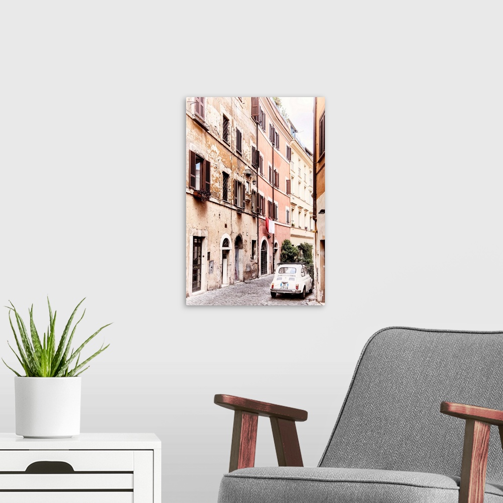 A modern room featuring It's an old white Fiat 500 parked in a beautiful old cobbled street in the center of Rome, Italy.