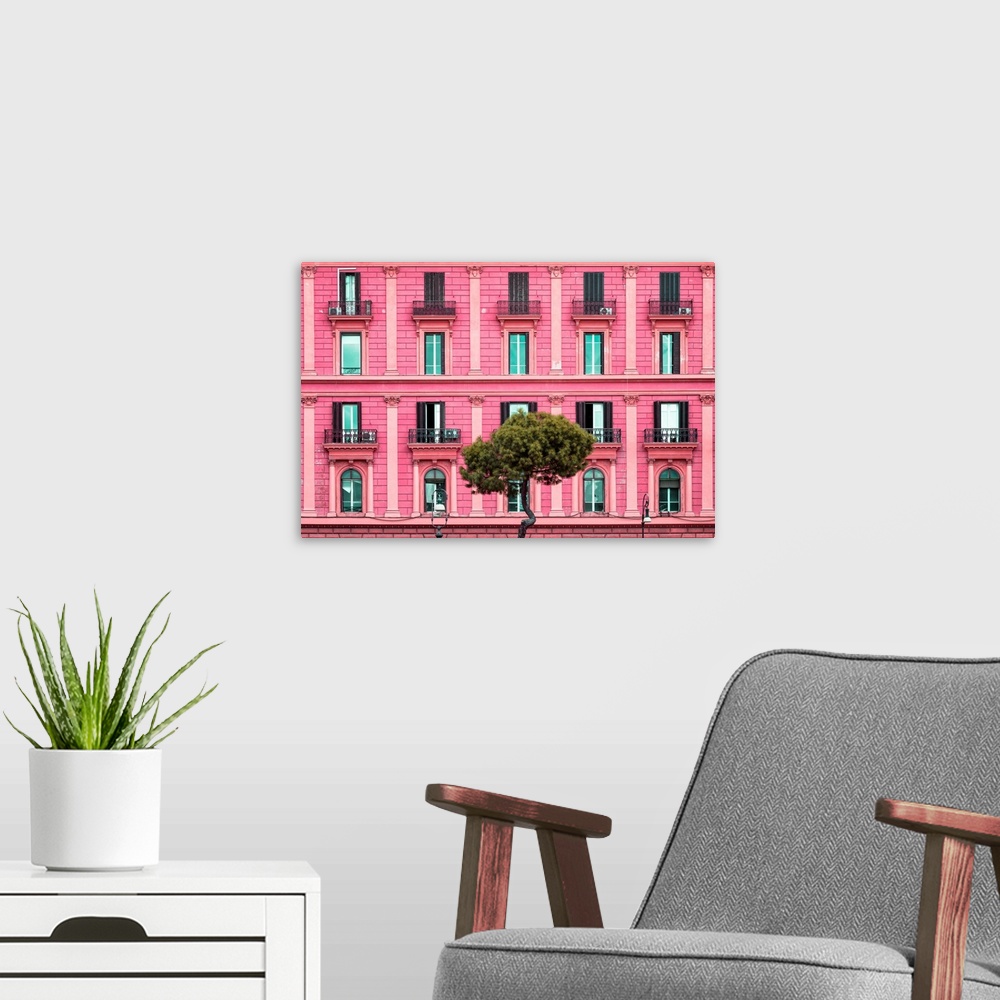 A modern room featuring It's a pink facade of a building in the city of Rome in Italy.