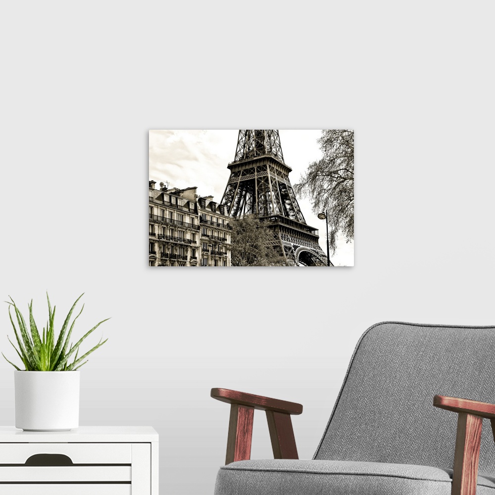 A modern room featuring Fine art photograph of the Eiffel Tower in France, with trees and buildings in the foreground.