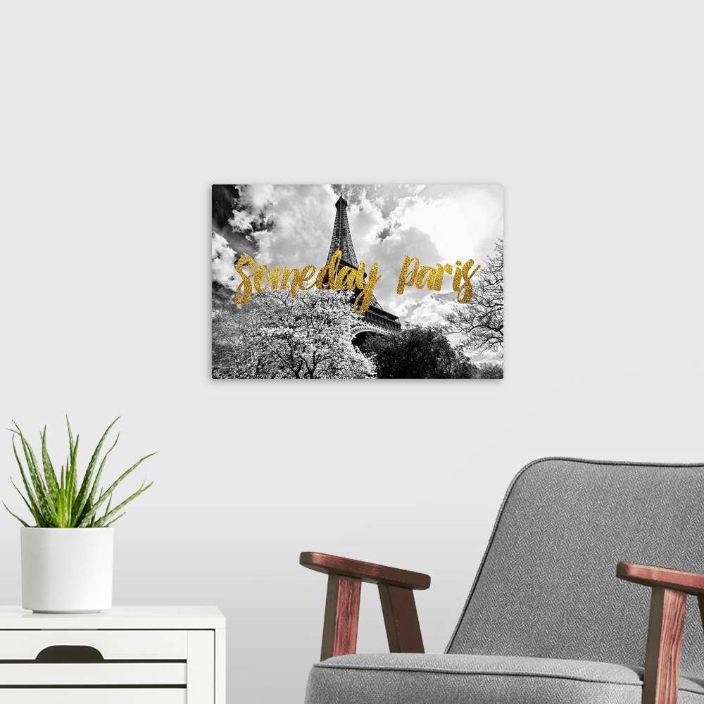 A modern room featuring Black and white photograph of the Eiffel Tower surrounded by treetops with the phrase "Someday Pa...