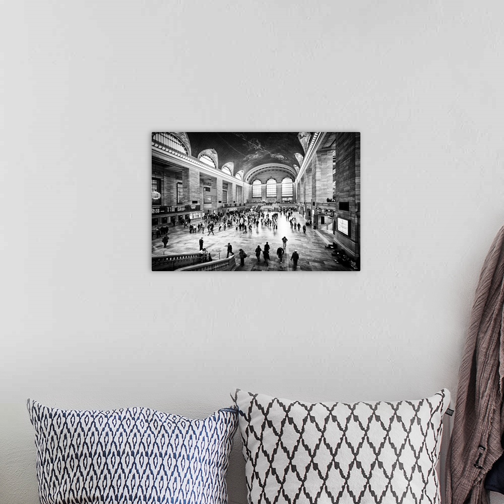 A bohemian room featuring A black and white photograph of the interior of Grand Central Station in New York City.