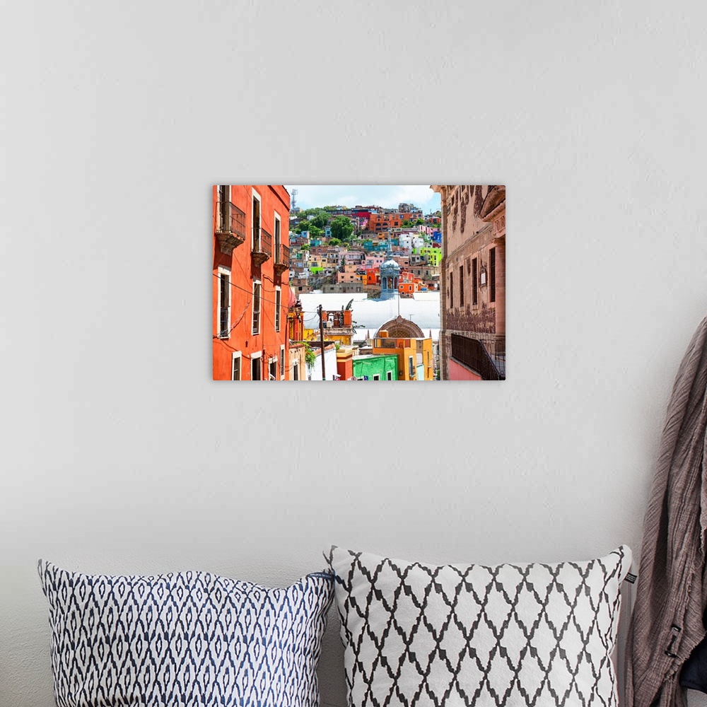 A bohemian room featuring Photograph of a Guanajuato, Mexico, cityscape displaying colorful buildings, homes, and church do...
