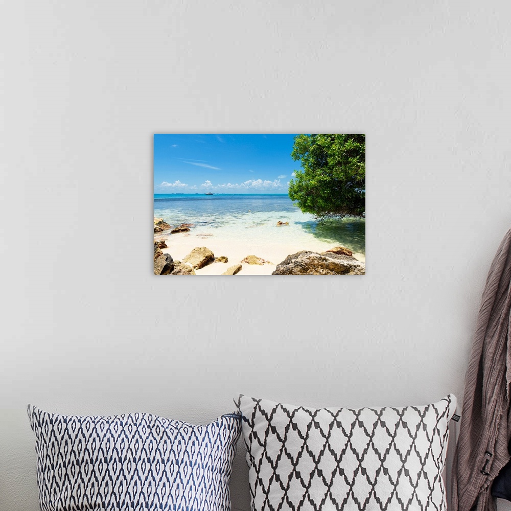 A bohemian room featuring Photograph of Isla Mujeres on the Caribbean coastline, Mexico, with a boat in the distance. From ...