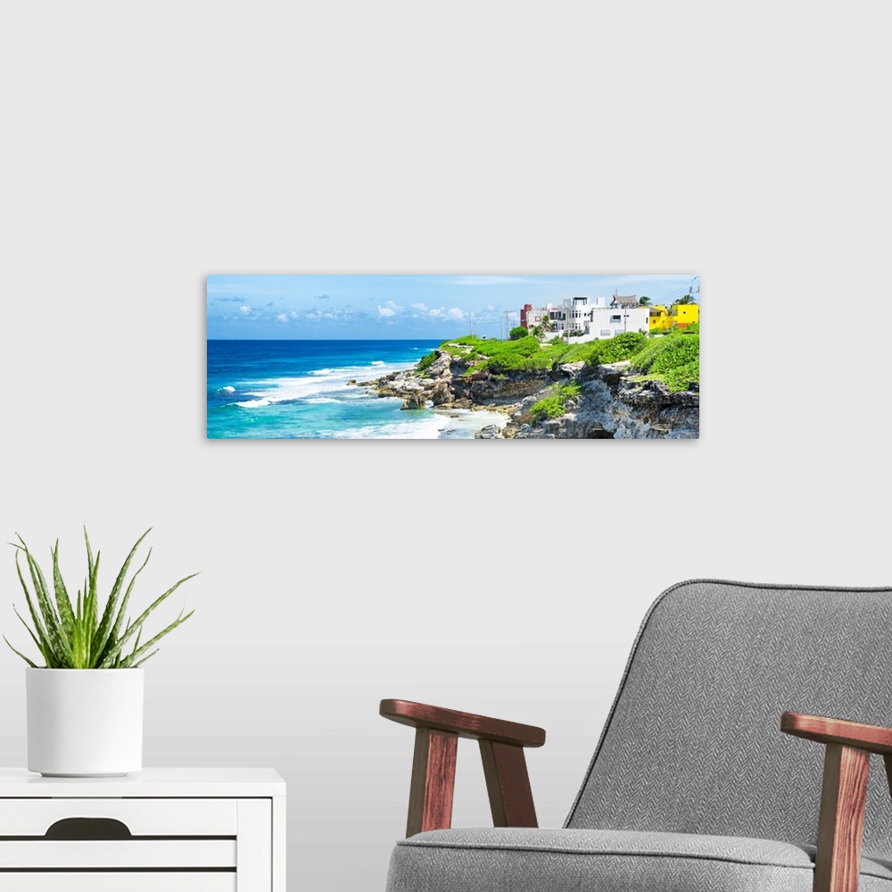 A modern room featuring Panoramic photograph of the Isla Mujeres coastline displaying a rocky shore and buildings in the ...