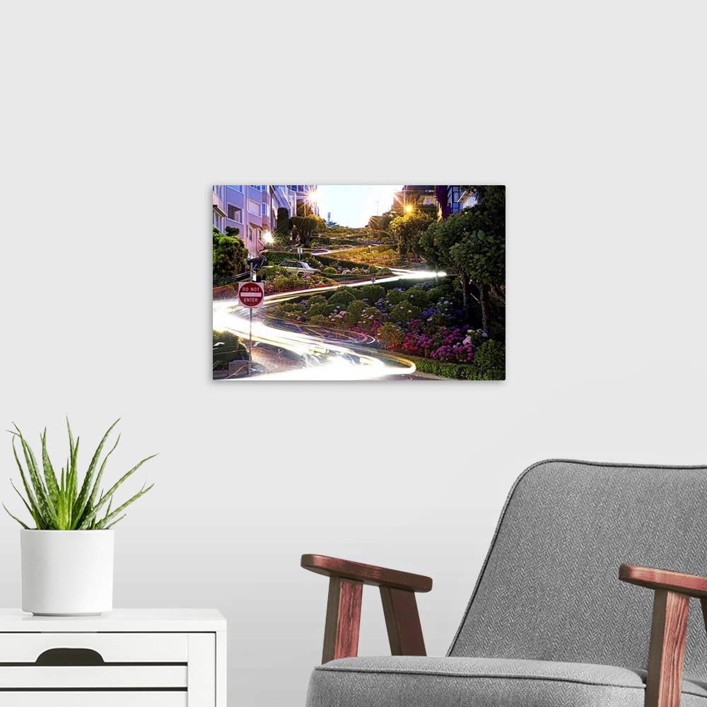 A modern room featuring Time lapse photo of light trails illuminates the switchbacks on Lombard Street.
