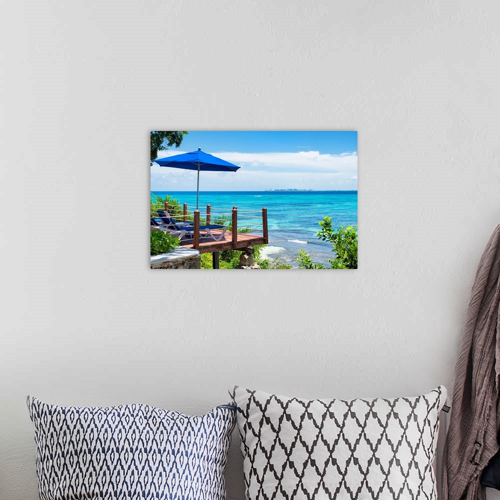 A bohemian room featuring Relaxing photograph of the clear Caribbean ocean with lounge chairs, an umbrella, and a city skyl...