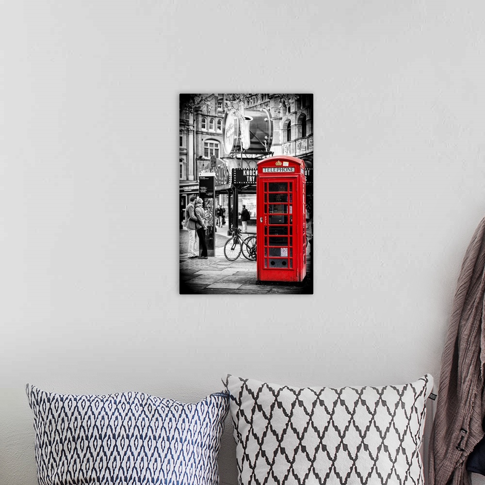 A bohemian room featuring A couple in love being passionate beside an iconic London telephone booth.