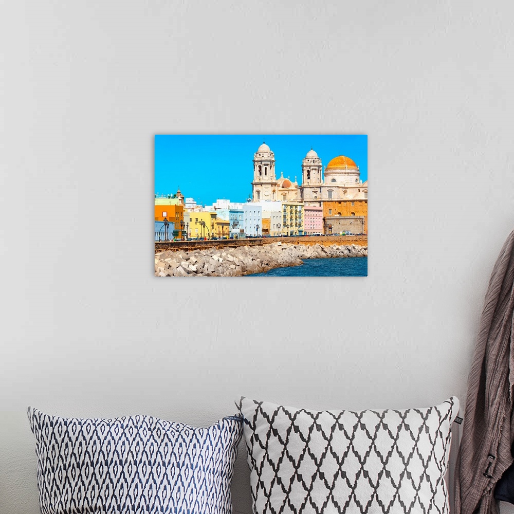 A bohemian room featuring It's the seaside on the city of Cadiz in Spain, with its colorful architecture.