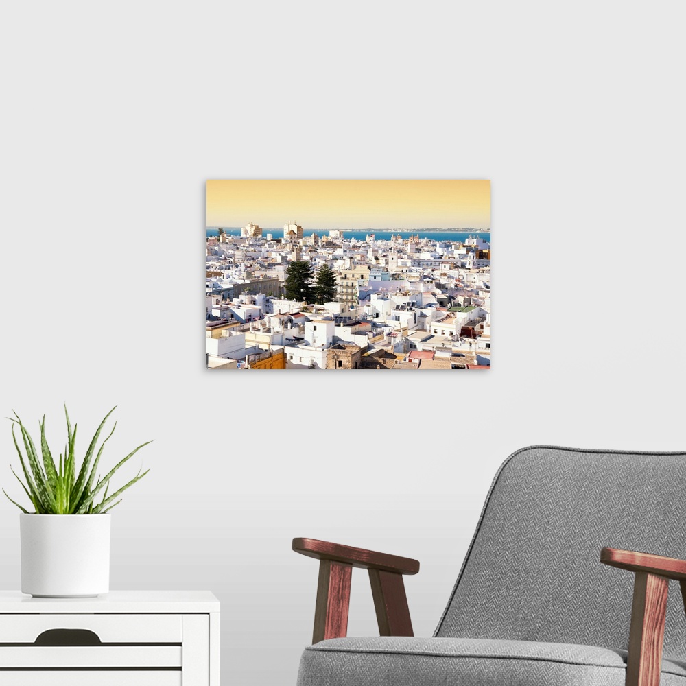 A modern room featuring It's a view of the beautiful city of Cadiz in Spain at sunset.