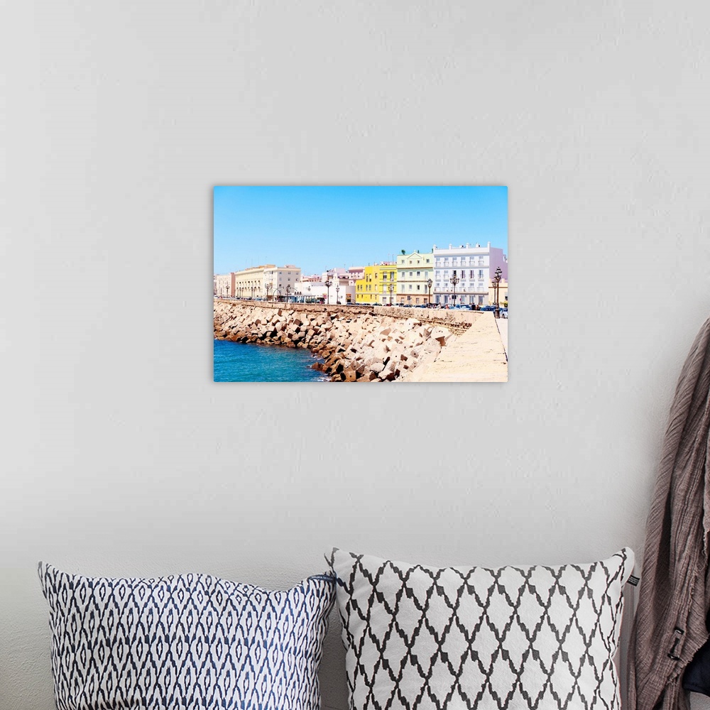 A bohemian room featuring These are the colorful buildings located in front of the seaside in Cadiz in Spain.