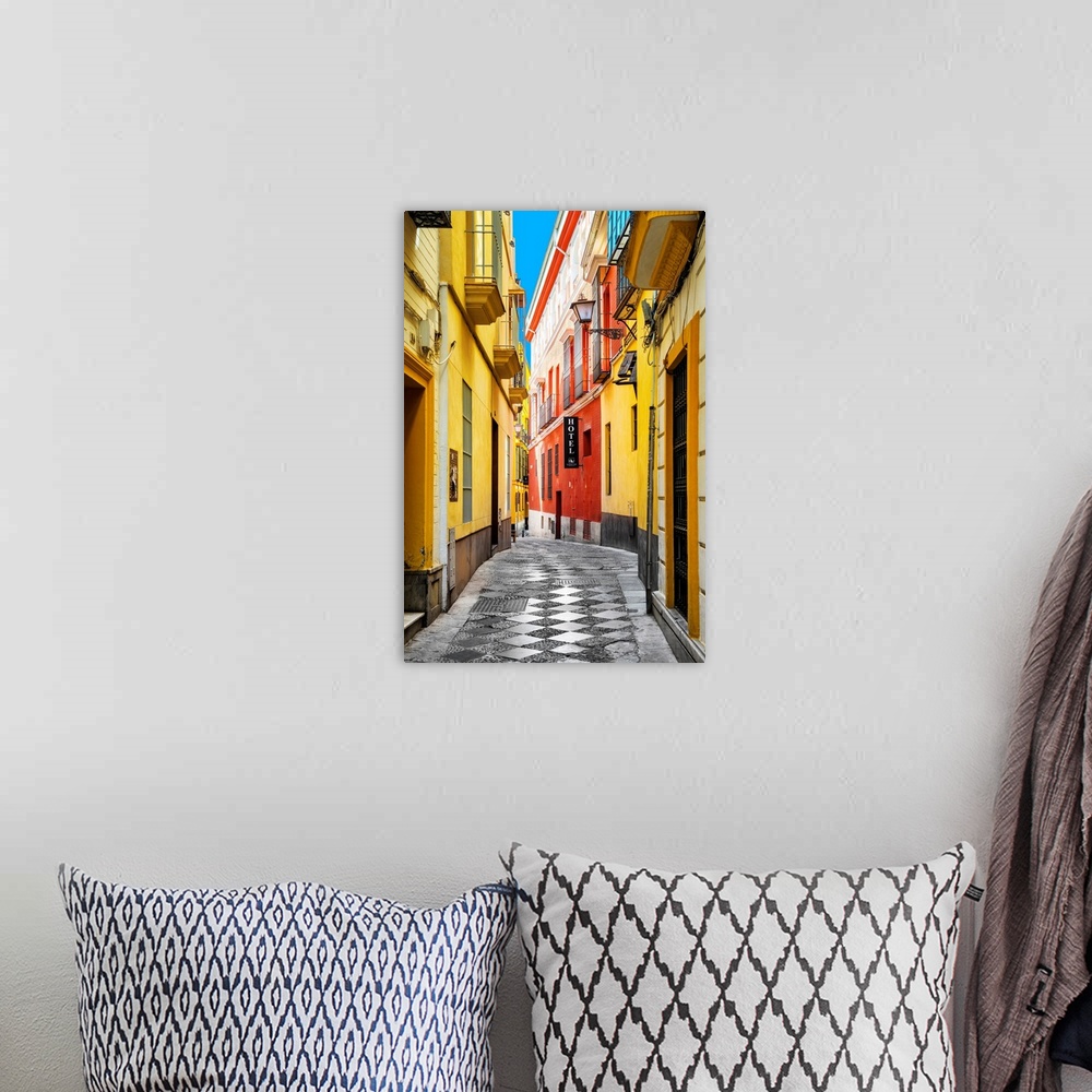 A bohemian room featuring It's a traditional spanish street with colorful facades in the city of Seville in Spain.