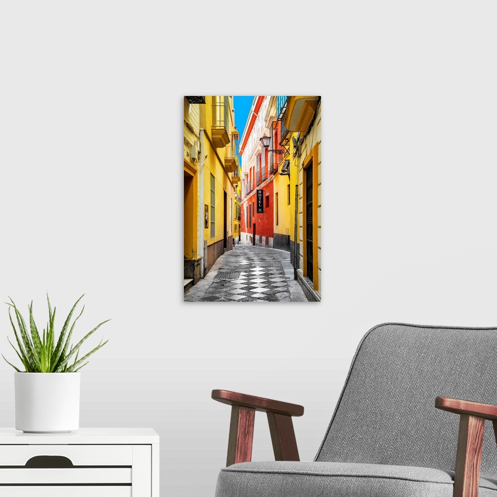 A modern room featuring It's a traditional spanish street with colorful facades in the city of Seville in Spain.