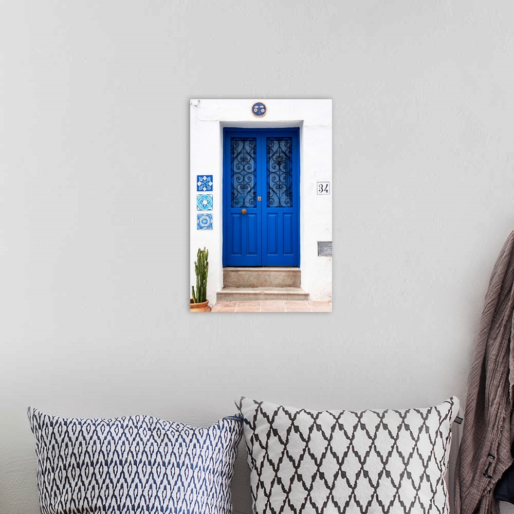 A bohemian room featuring It's an old blue door on a white wall in Mijas, Spain.
