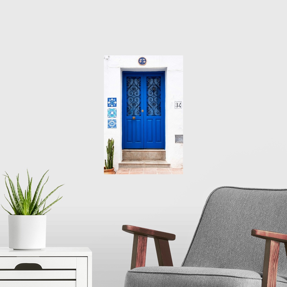 A modern room featuring It's an old blue door on a white wall in Mijas, Spain.