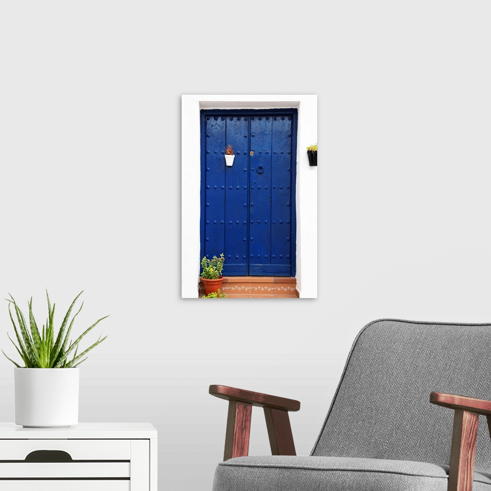A modern room featuring It's an old blue marine door in Mijas, Spain.