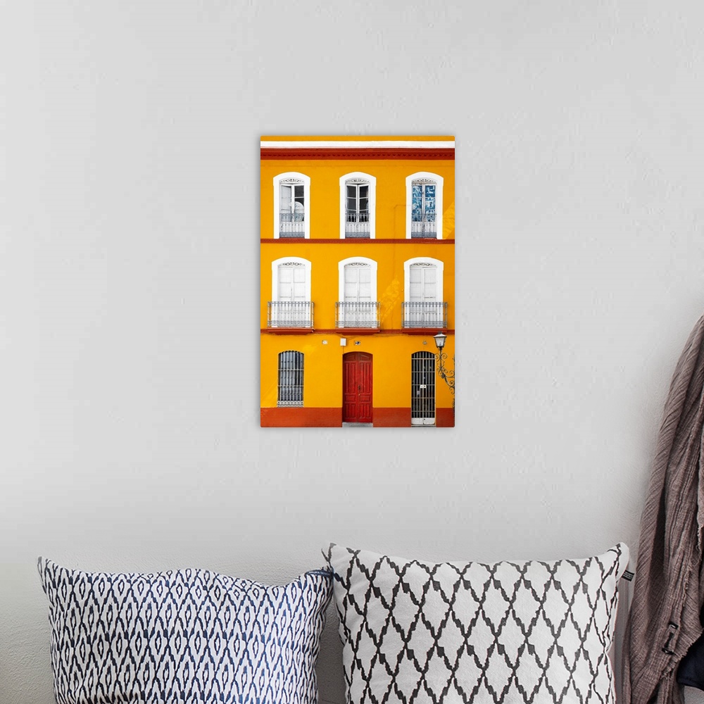 A bohemian room featuring It's a beautiful orange facade of an old building in Seville, Spain.