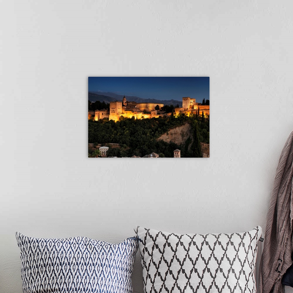 A bohemian room featuring It's a magnificent view of the Alhambra by night in Granada, Spain.