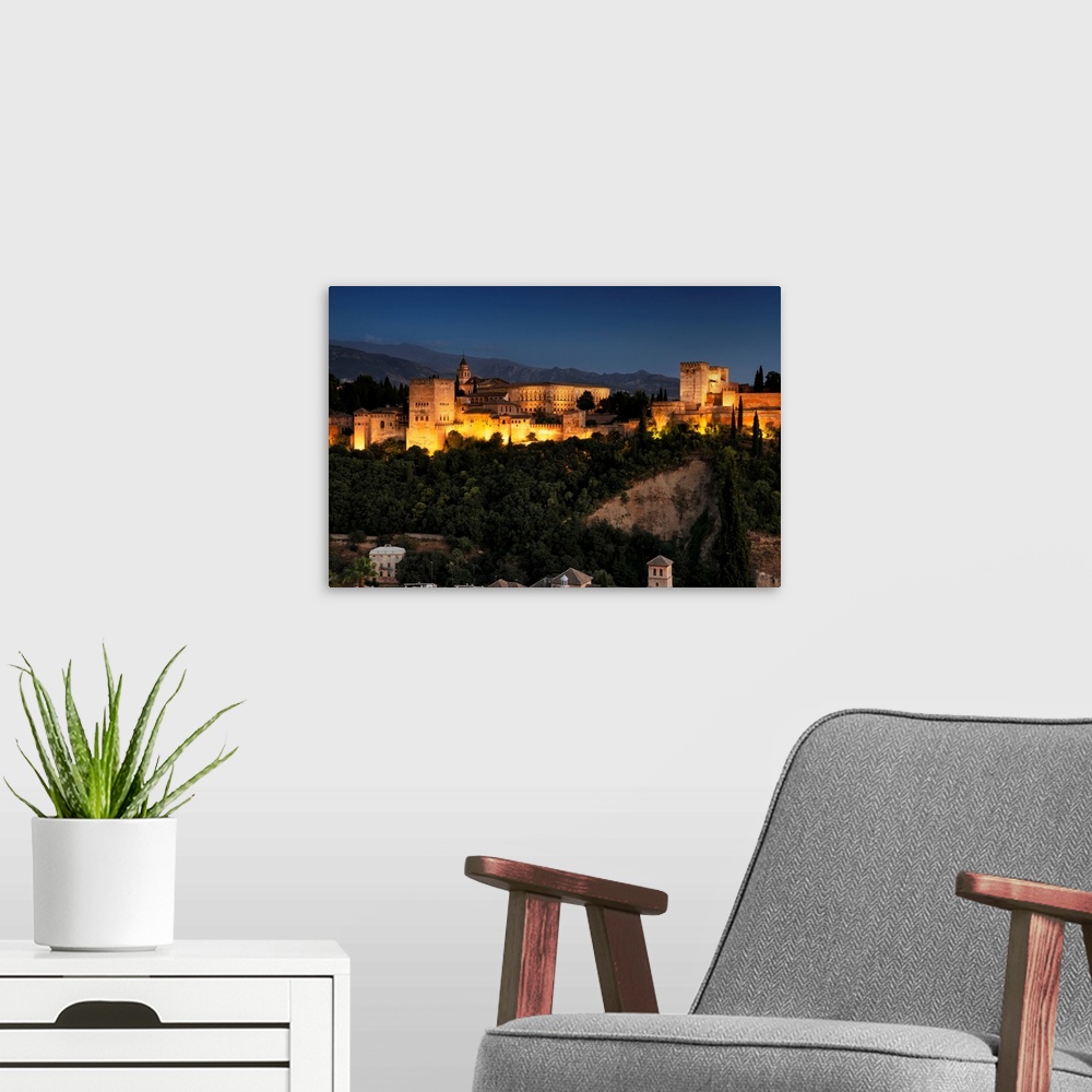 A modern room featuring It's a magnificent view of the Alhambra by night in Granada, Spain.