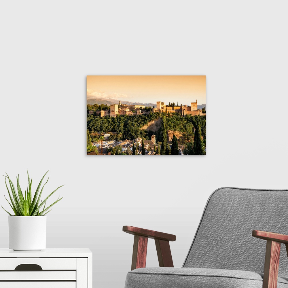 A modern room featuring It's a magnificent view of the Alhambra at sunset in Granada, Spain.