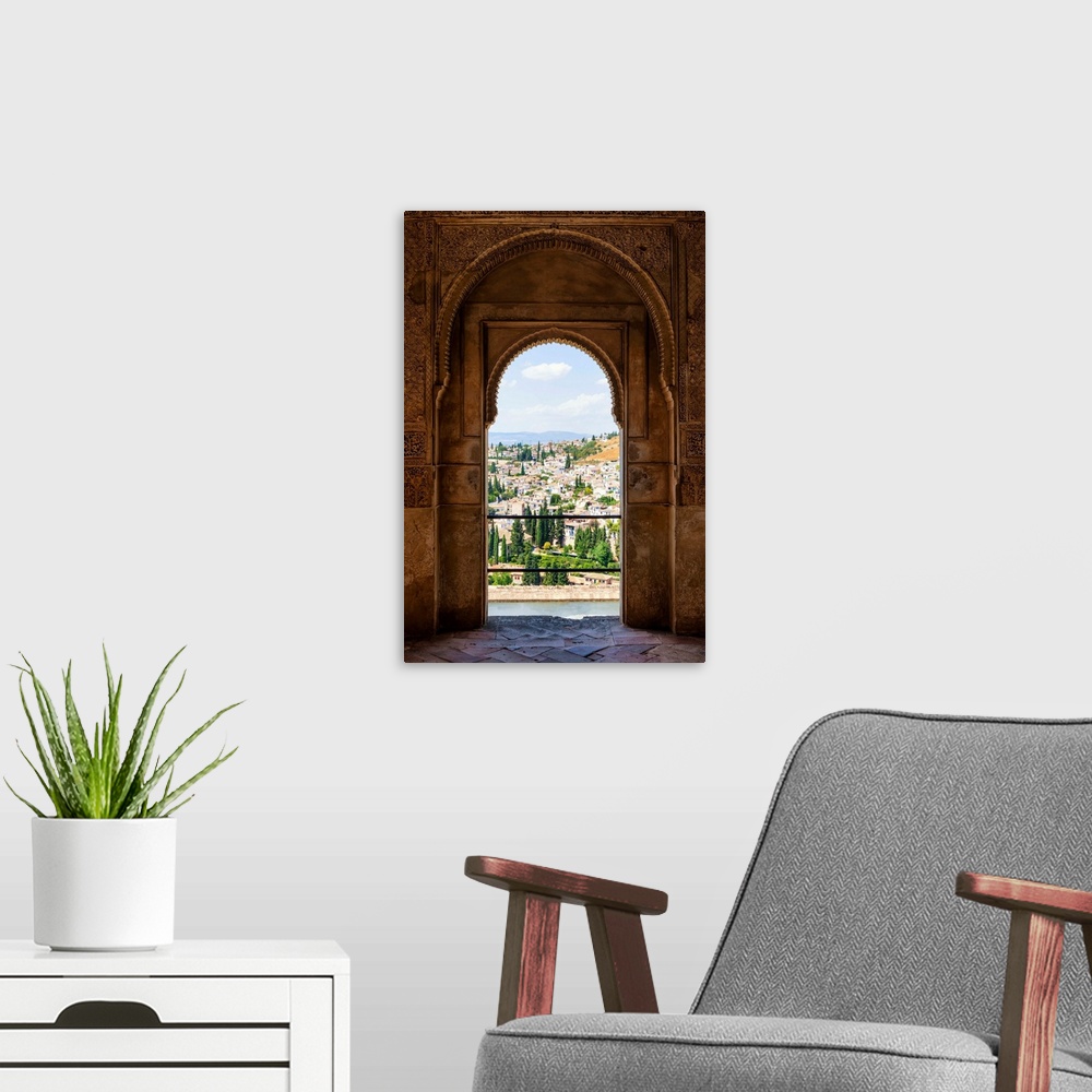 A modern room featuring It's a view of the city of Granada by the ancient arches of the Alhambra, Spain.