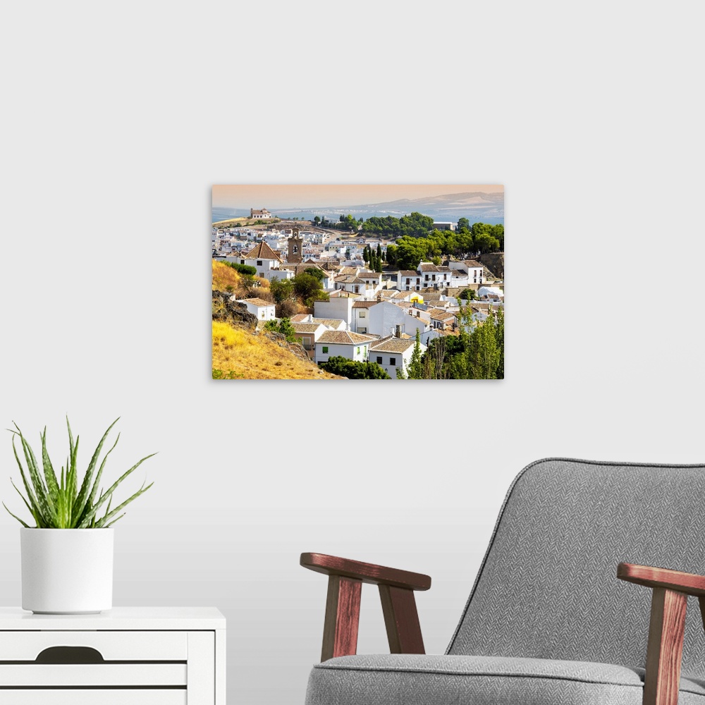 A modern room featuring It's a view of the white city of Antequera in Spain.