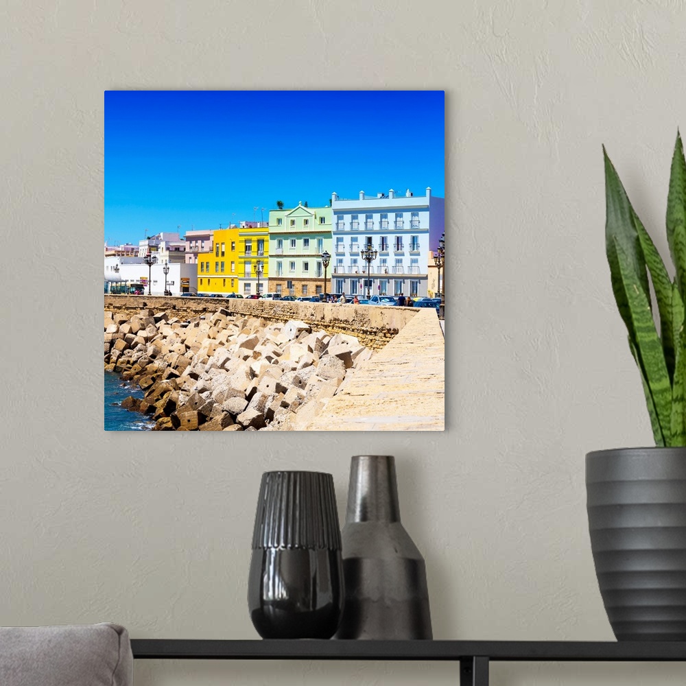 A modern room featuring These are the colorful buildings located in front of the seaside in Cadiz in Spain.