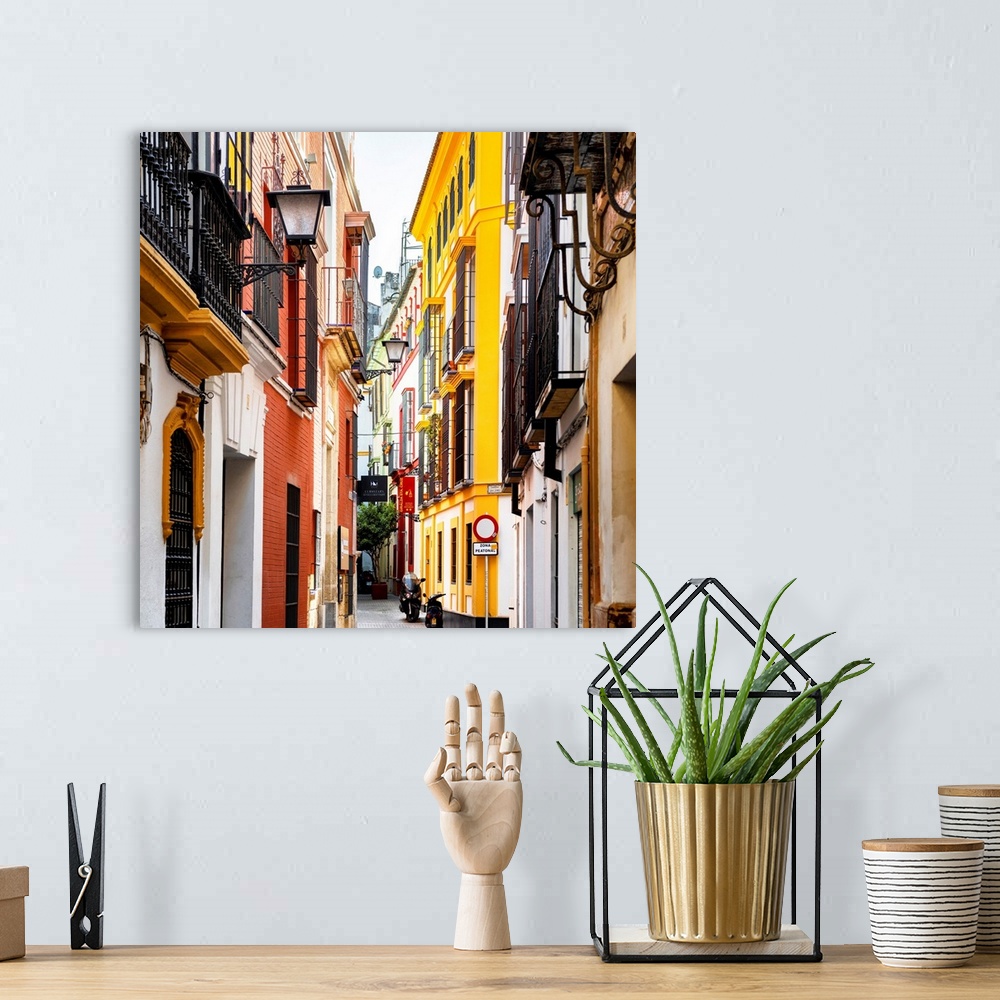 A bohemian room featuring It's a traditional street with colorful facades in the city of Seville in Spain.