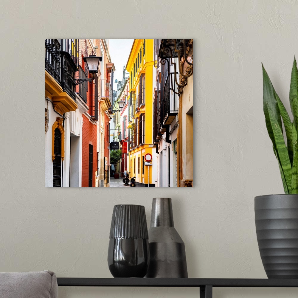 A modern room featuring It's a traditional street with colorful facades in the city of Seville in Spain.