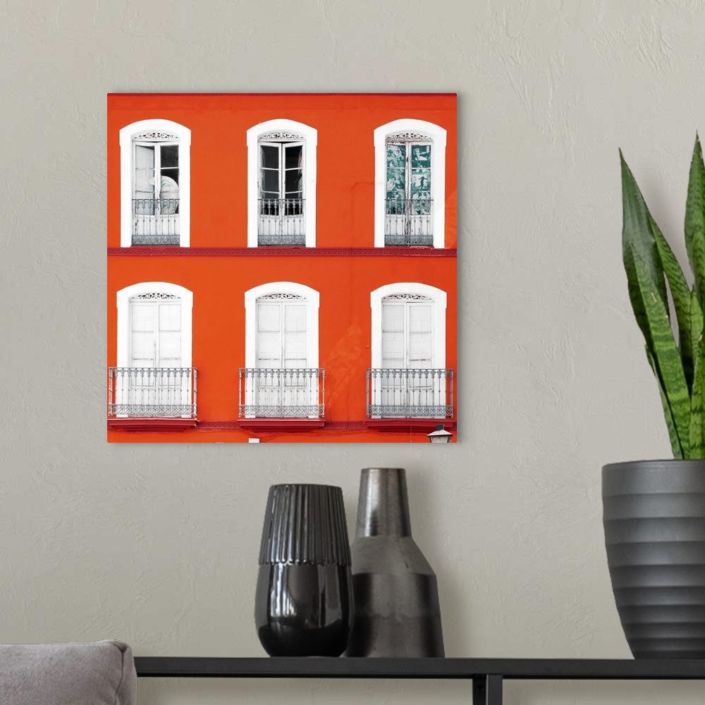 A modern room featuring It's a beautiful orange facade of an old building in Seville, Spain.
