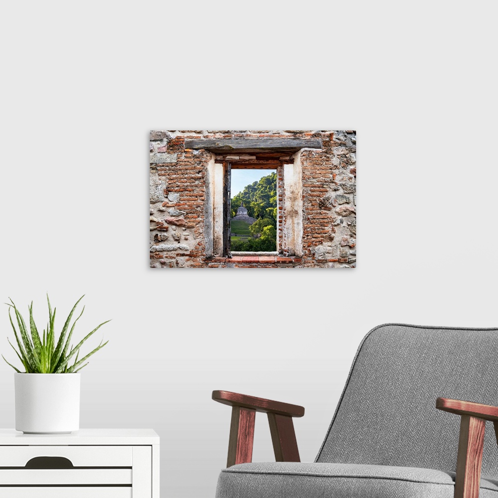 A modern room featuring View of the sunrise over the Mayan Ruins in Palenque, Mexico, framed through a stony, brick windo...