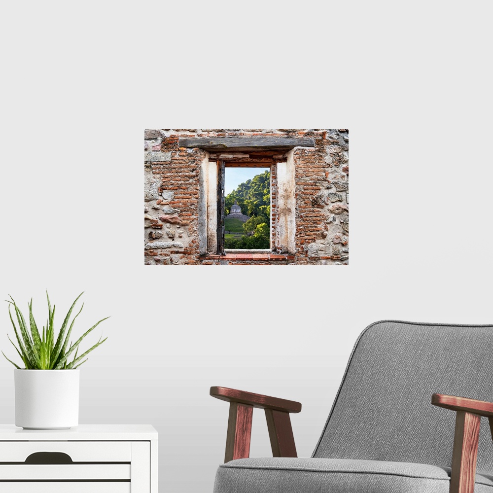 A modern room featuring View of the sunrise over the Mayan Ruins in Palenque, Mexico, framed through a stony, brick windo...