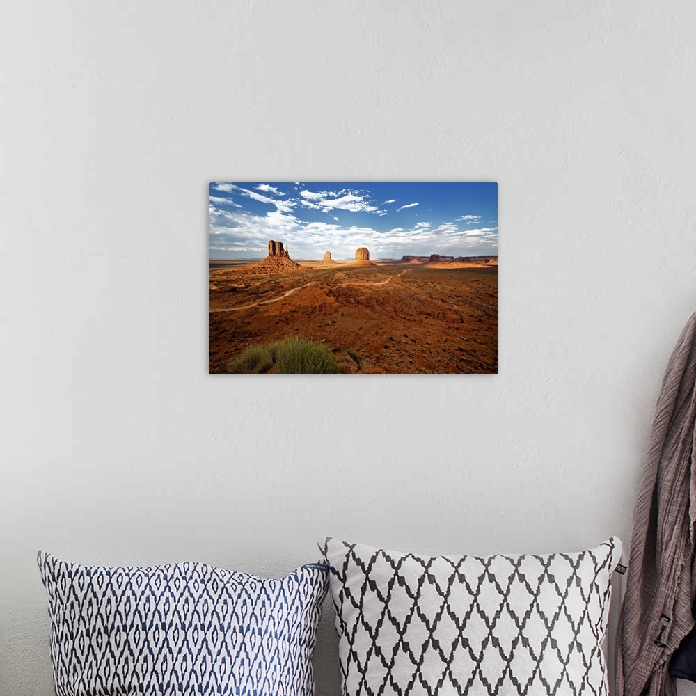 A bohemian room featuring Large rock formations in the desert landscape of Monument Valley.