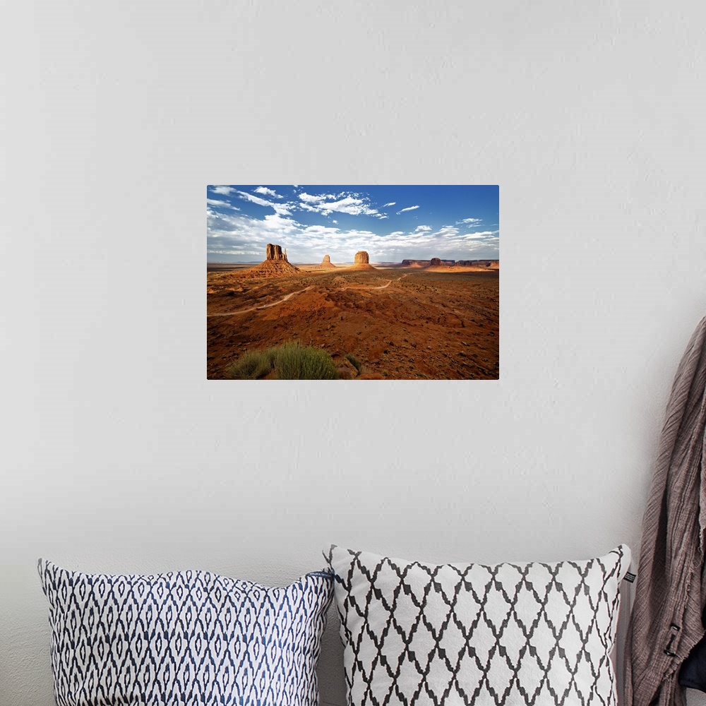 A bohemian room featuring Large rock formations in the desert landscape of Monument Valley.
