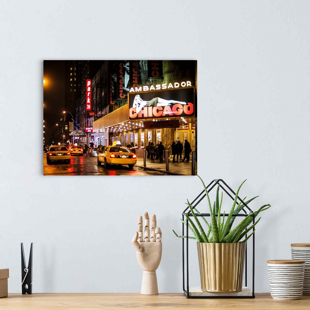 A bohemian room featuring A photograph of Broadway at night, New York city.